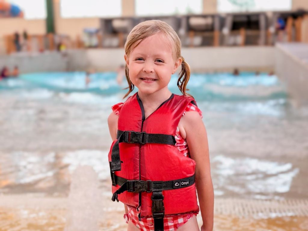 Child in life vest at the indoor water park at Great Wolf Lodge.
